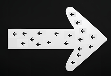 A large white arrow pointing to the right, encompassing multiple small black arrows pointing to the left.